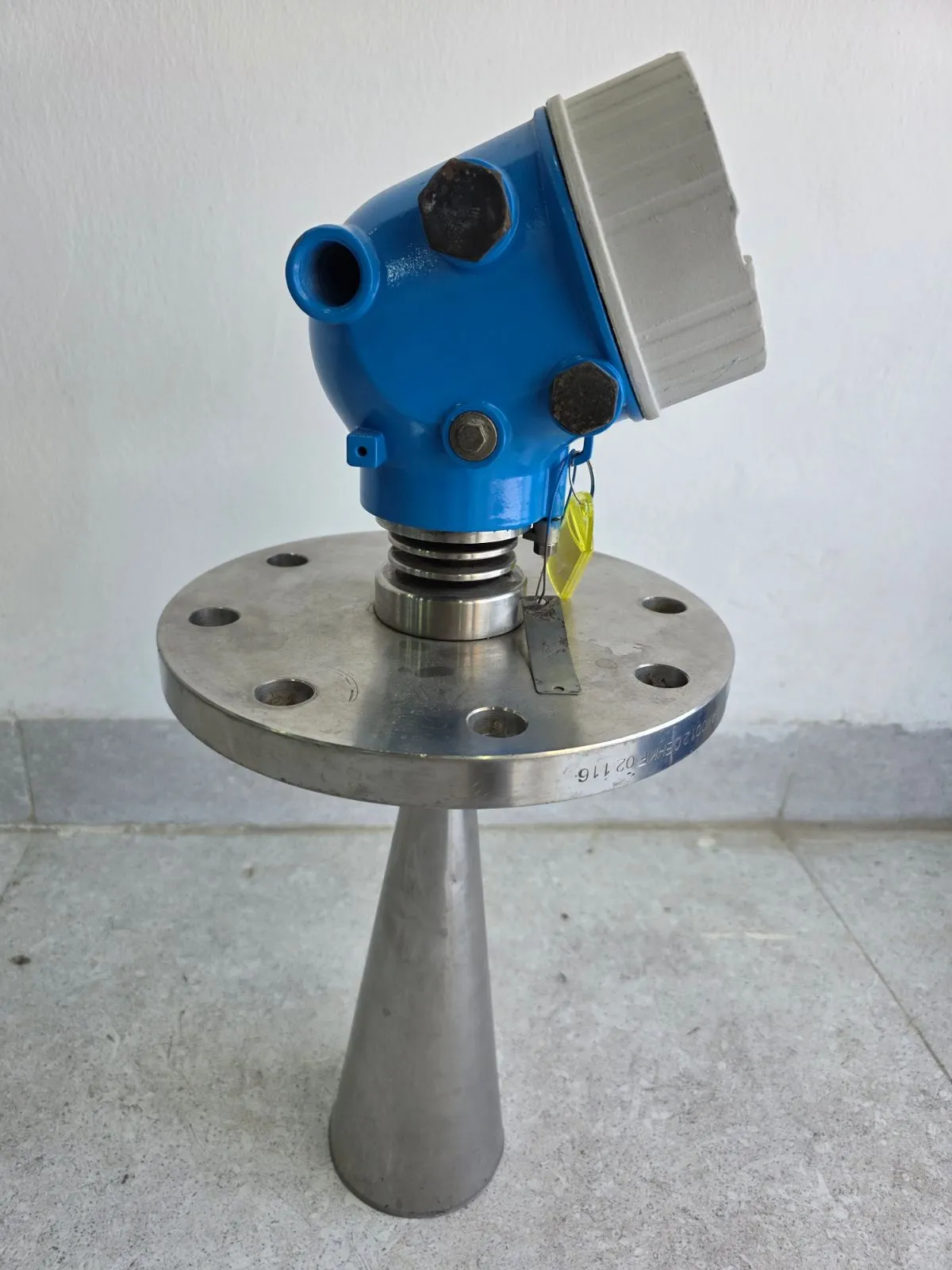 Side view of the blue housing and horn antenna on the stainless-steel flange