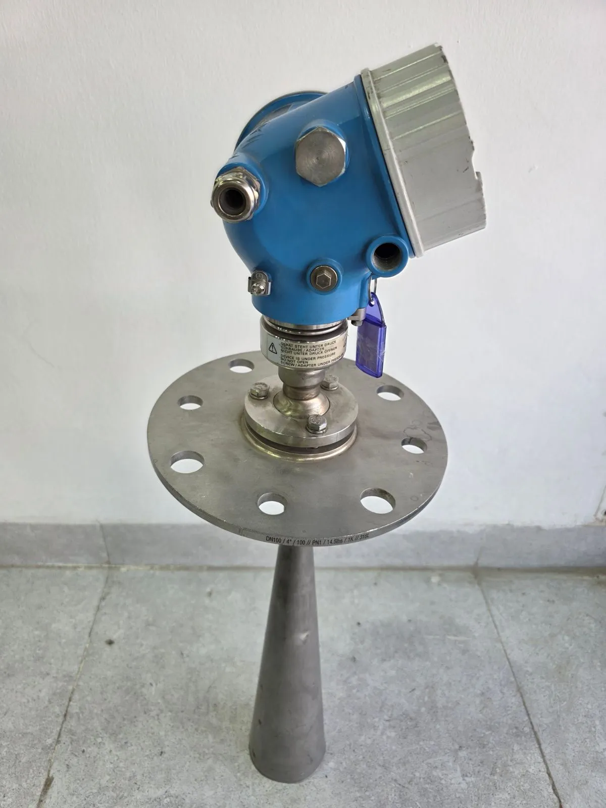 Angled view of the FMR57 radar level transmitter and its stainless-steel horn antenna on a flange