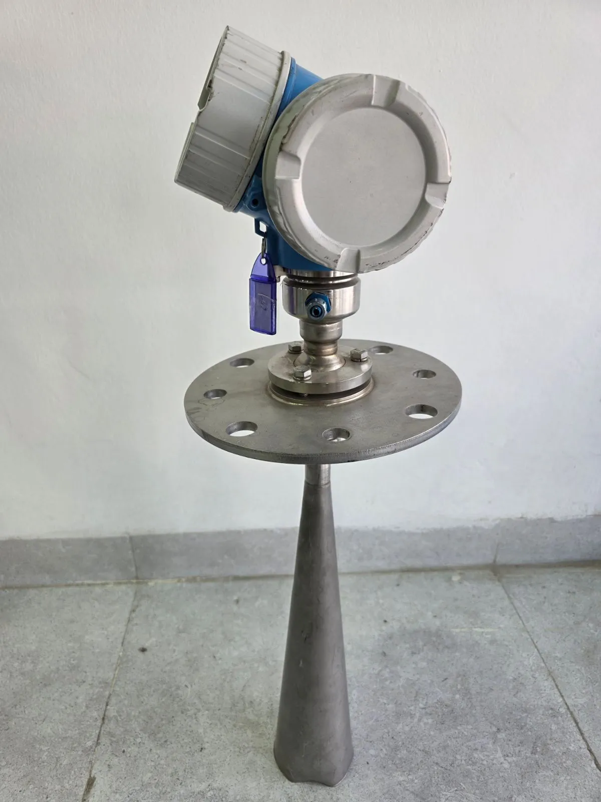 Side view of the FMR57 blue electronics head and conical antenna with the housing covers closed