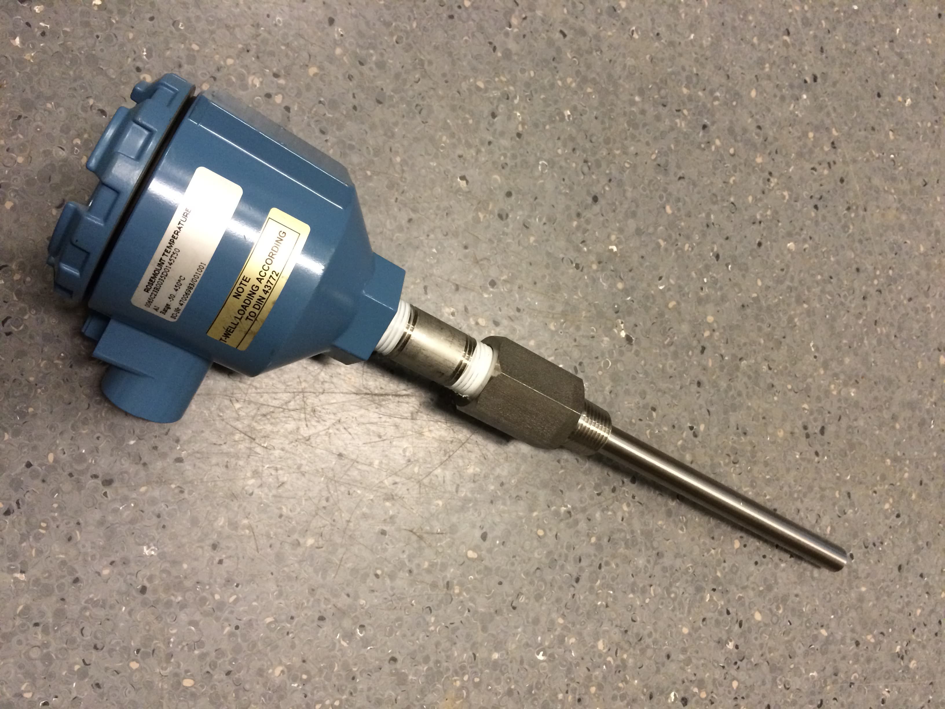 Rosemount temperature transmitter mounted on a stainless thermowell/probe assembly — real installation photo