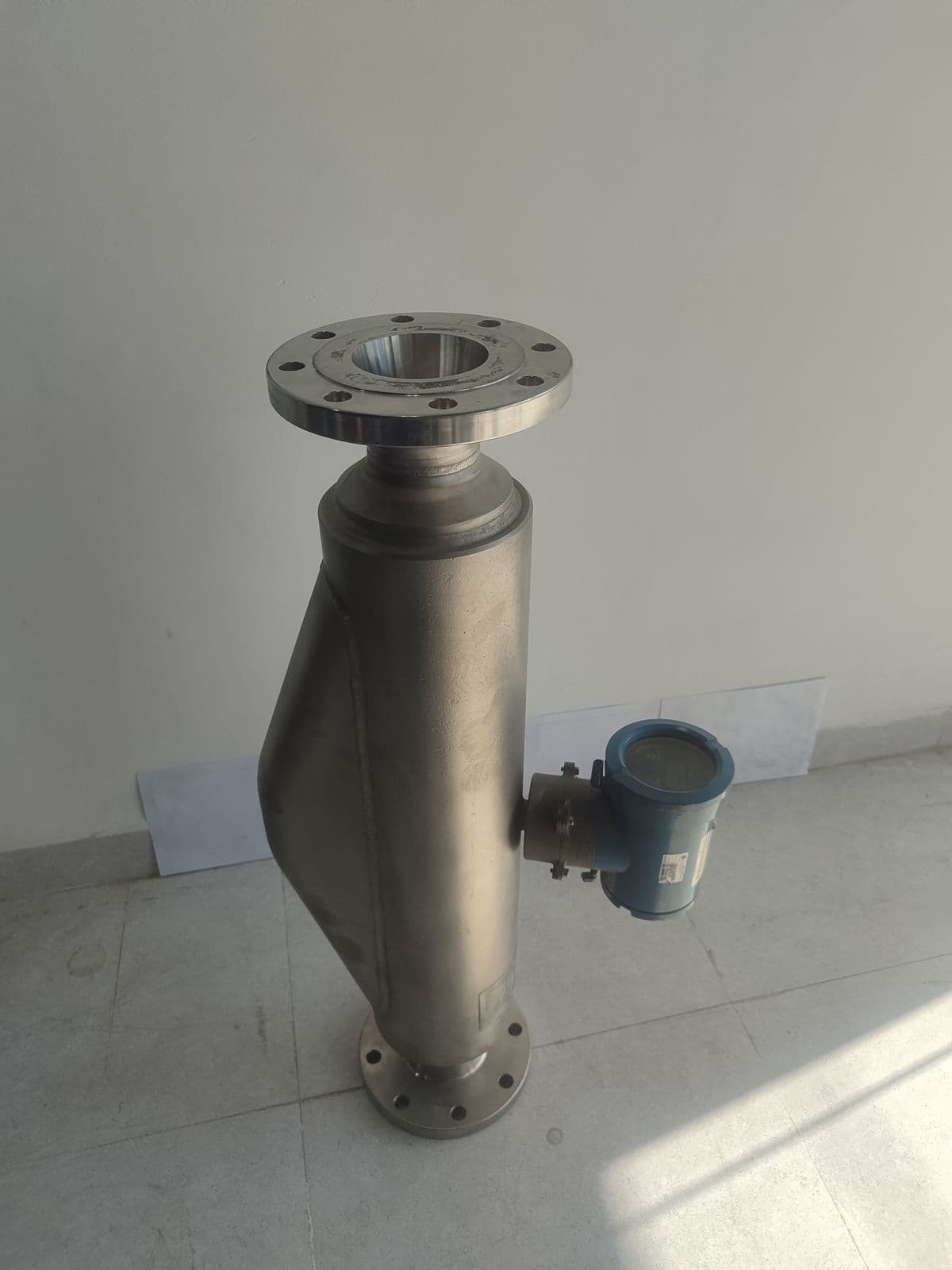 The reducing-flange unit from the side — 4″ flange on a 3″ hub, meter body and integral head